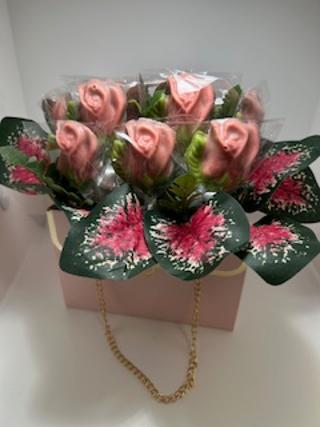 one dozen chocolate Roses in a purse